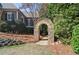 Beautiful landscaping with an stone archway and a path through lush greenery and colorful flowers at 2813 Long Grove Ct, Marietta, GA 30062