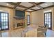 Inviting living room with stone fireplace, exposed beam ceiling, and access to outdoor spaces at 2813 Long Grove Ct, Marietta, GA 30062