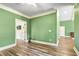 Bright bedroom featuring wood flooring and green walls at 650 New Morn Dr, Hampton, GA 30228