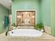 Luxurious bathroom featuring a standalone tub and glass-enclosed shower at 650 New Morn Dr, Hampton, GA 30228