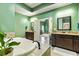 A luxury bathroom with a soaking tub, double sinks, and a doorway to the primary bedroom at 650 New Morn Dr, Hampton, GA 30228