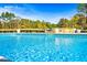 Inviting in-ground pool features mosaic tile and stone waterfall, creating a backyard oasis at 650 New Morn Dr, Hampton, GA 30228