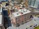 An aerial view looking down at the brick apartment building in a perfect location at 115 W Peachtree Nw Pl # 602, Atlanta, GA 30313