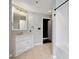 Well-lit bathroom with white tiled shower/tub, vanity with marble top, and neutral tile flooring at 115 W Peachtree Nw Pl # 602, Atlanta, GA 30313