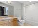 Bright bathroom featuring a single sink vanity and a shower-tub combo with tiled walls at 115 W Peachtree Nw Pl # 602, Atlanta, GA 30313