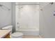 Clean bathroom featuring a toilet, gray walls, a shower-tub combo with silver trim and tile surround at 115 W Peachtree Nw Pl # 602, Atlanta, GA 30313