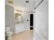 Well-lit bathroom with white tiled shower/tub, vanity with marble top, and neutral tile flooring at 115 W Peachtree Nw Pl # 602, Atlanta, GA 30313