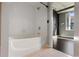 Bathroom with tiled bathtub and view through doorway into bedroom with hardwood floors at 115 W Peachtree Nw Pl # 602, Atlanta, GA 30313