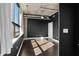 Bedroom featuring hardwood floors, black accent wall, and large bright window at 115 W Peachtree Nw Pl # 602, Atlanta, GA 30313
