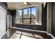 Bedroom showing neutral decor, hardwood floors, black accent walls, and a downtown view at 115 W Peachtree Nw Pl # 602, Atlanta, GA 30313