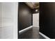 The entry area features dark walls, tile floors, and a white door, providing a welcoming atmosphere at 115 W Peachtree Nw Pl # 602, Atlanta, GA 30313