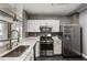 Well-designed kitchen featuring stainless steel appliances, marble countertops and black tile backsplash at 115 W Peachtree Nw Pl # 602, Atlanta, GA 30313