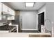 Well-equipped kitchen featuring stainless steel appliances, stylish backsplash, and convenient in-unit laundry at 115 W Peachtree Nw Pl # 602, Atlanta, GA 30313