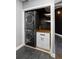 Convenient in-unit laundry closet with stacked washer and dryer and storage space at 115 W Peachtree Nw Pl # 602, Atlanta, GA 30313