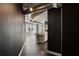 Open living space with exposed ductwork, hardwood floors, and city views from the large windows at 115 W Peachtree Nw Pl # 602, Atlanta, GA 30313