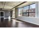 Bright living room featuring hardwood floors, industrial ductwork, and an abundance of natural light at 115 W Peachtree Nw Pl # 602, Atlanta, GA 30313