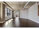 Spacious living room featuring hardwood floors, concrete pillars and exposed ductwork, filled with natural light at 115 W Peachtree Nw Pl # 602, Atlanta, GA 30313