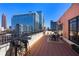 Relax on this rooftop patio offering a city view, perfect for entertaining with bistro tables and brick pavers at 115 W Peachtree Nw Pl # 602, Atlanta, GA 30313