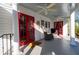 Covered back porch with white columns, ceiling fans, and sitting area with red doors at 255 Maple Nw Ave, Marietta, GA 30064