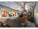 Expansive backyard with a cozy brick fireplace, a stone patio and a covered porch with comfortable seating at 255 Maple Nw Ave, Marietta, GA 30064