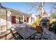 Spacious backyard with a stone patio, brick fireplace, and outdoor dining area at 255 Maple Nw Ave, Marietta, GA 30064