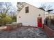 Backyard with a stone patio, outdoor kitchen with grill, red door, and nice backyard at 255 Maple Nw Ave, Marietta, GA 30064