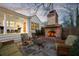 Cozy backyard patio featuring a brick fireplace, comfortable seating, and a charming covered porch at 255 Maple Nw Ave, Marietta, GA 30064