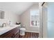 Bright bathroom featuring a vanity with a dark wood cabinet, and glass-enclosed shower at 255 Maple Nw Ave, Marietta, GA 30064