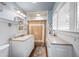 Bathroom with tiled shower and vanity, complete with storage at 255 Maple Nw Ave, Marietta, GA 30064