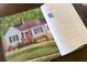Book showing the home's exterior, showcasing its classic curb appeal and well-kept landscaping at 255 Maple Nw Ave, Marietta, GA 30064