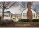 Quaint home featuring a charming front porch, mature trees, and well-manicured landscaping, set against a beautiful sky at 255 Maple Nw Ave, Marietta, GA 30064