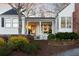 Charming front porch featuring a red door, white columns, and a cozy seating area with a rocking chair at 255 Maple Nw Ave, Marietta, GA 30064