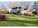 Charming one-story home features a lush front yard with a vibrant red door and mature landscaping at 255 Maple Nw Ave, Marietta, GA 30064