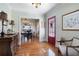 Hallway leading to the dining room with hardwood floors and a glimpse of the kitchen at 255 Maple Nw Ave, Marietta, GA 30064