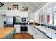 A kitchen with stainless steel appliances, white cabinetry, a butcher block island and hardwood floors at 255 Maple Nw Ave, Marietta, GA 30064