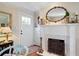 Cozy living room featuring a fireplace, hardwood floors, and an ornate decorative mirror at 255 Maple Nw Ave, Marietta, GA 30064