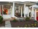 Inviting outdoor living space with a brick fireplace and elegant column-lined covered porch, perfect for entertaining at 255 Maple Nw Ave, Marietta, GA 30064
