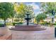 A beautiful town fountain surrounded by trees, benches, and lovely landscaping at 255 Maple Nw Ave, Marietta, GA 30064