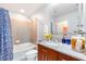 Stylish bathroom with granite counters, wood cabinets, and a convenient shower-tub combination at 361 17Th Nw St # 1610, Atlanta, GA 30363