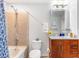 Well-lit bathroom with granite counters, wood cabinets, and a shower-tub combo at 361 17Th Nw St # 1610, Atlanta, GA 30363