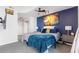 Well appointed bedroom featuring modern blue accent wall, contemporary decor, and ambient lighting at 361 17Th Nw St # 1610, Atlanta, GA 30363