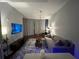 Inviting living room featuring a neutral color palette, plush sofa, and modern lighting fixture at 361 17Th Nw St # 1610, Atlanta, GA 30363