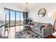 Living room with hardwood floors, modern lighting, neutral colors, and a large window with city views at 361 17Th Nw St # 1610, Atlanta, GA 30363