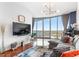 Bright living room with floor-to-ceiling windows offering panoramic views and stylish, comfortable furnishings at 361 17Th Nw St # 1610, Atlanta, GA 30363