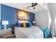 Stylish main bedroom with a blue accent wall, accent lighting, and modern decor at 361 17Th Nw St # 1610, Atlanta, GA 30363