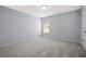 A serene bedroom featuring neutral carpet, light gray walls and a window at 3845 Alden Place, Cumming, GA 30028