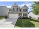 Two story home, front exterior with a well maintained lawn and driveway leading to the attached two car garage at 3845 Alden Place, Cumming, GA 30028