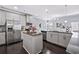 Modern kitchen featuring stainless steel appliances, dark wood floors, and a kitchen island at 3845 Alden Place, Cumming, GA 30028