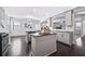 Contemporary kitchen with a central island, stainless steel appliances, and dark wood floors at 3845 Alden Place, Cumming, GA 30028