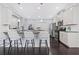 Bright kitchen featuring an island, white cabinetry, and stainless steel appliances at 3845 Alden Place, Cumming, GA 30028